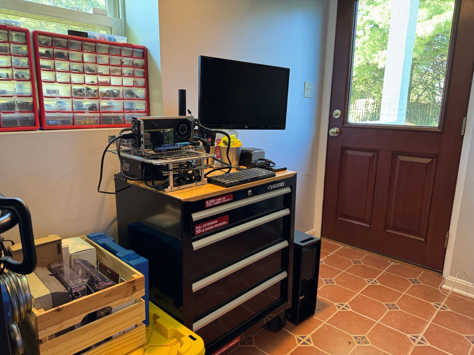 Open-frame hardware test bench with motherboard, GPU, and instrumentation on a workshop cart